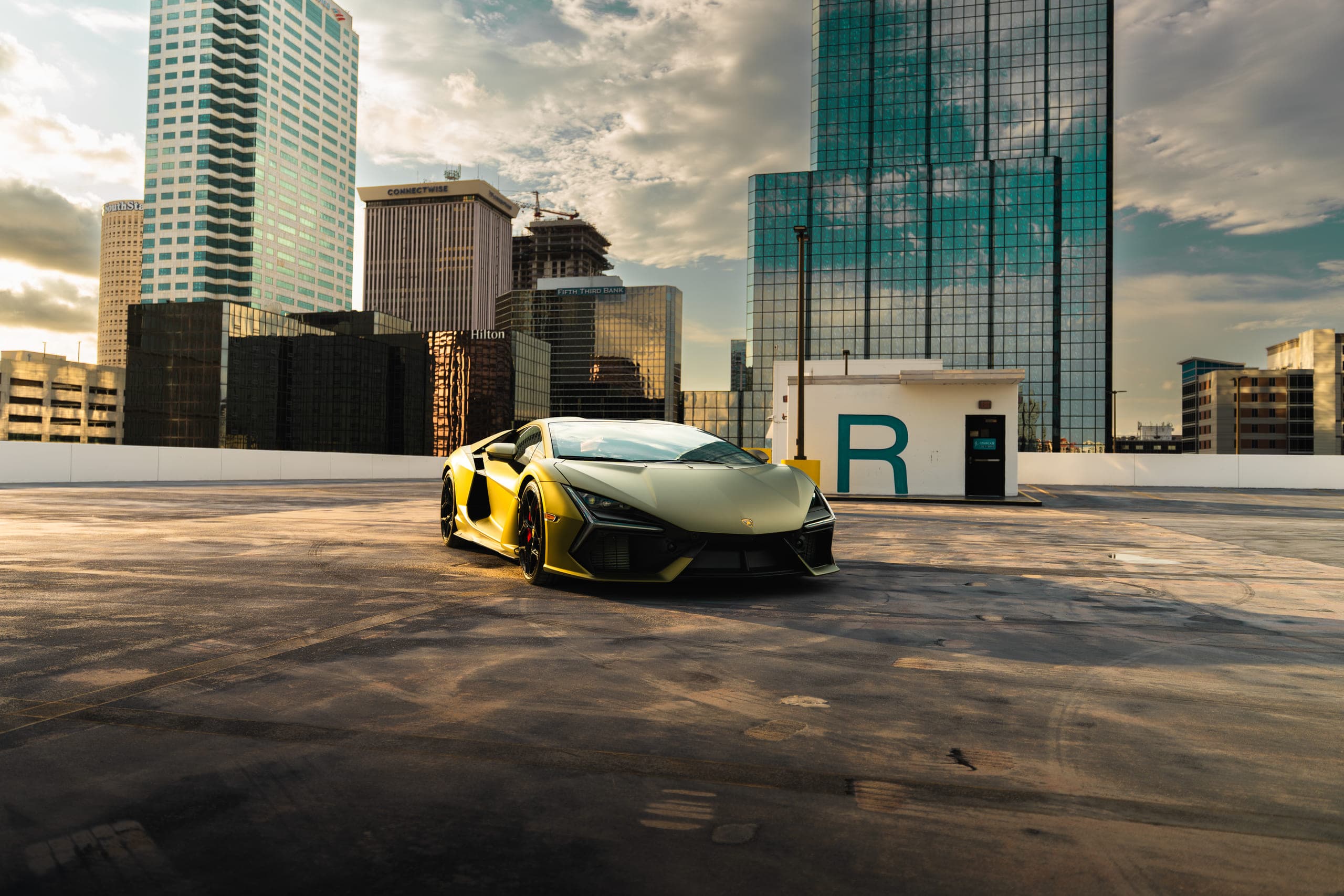 A sports car on a rooftop against the city skyline