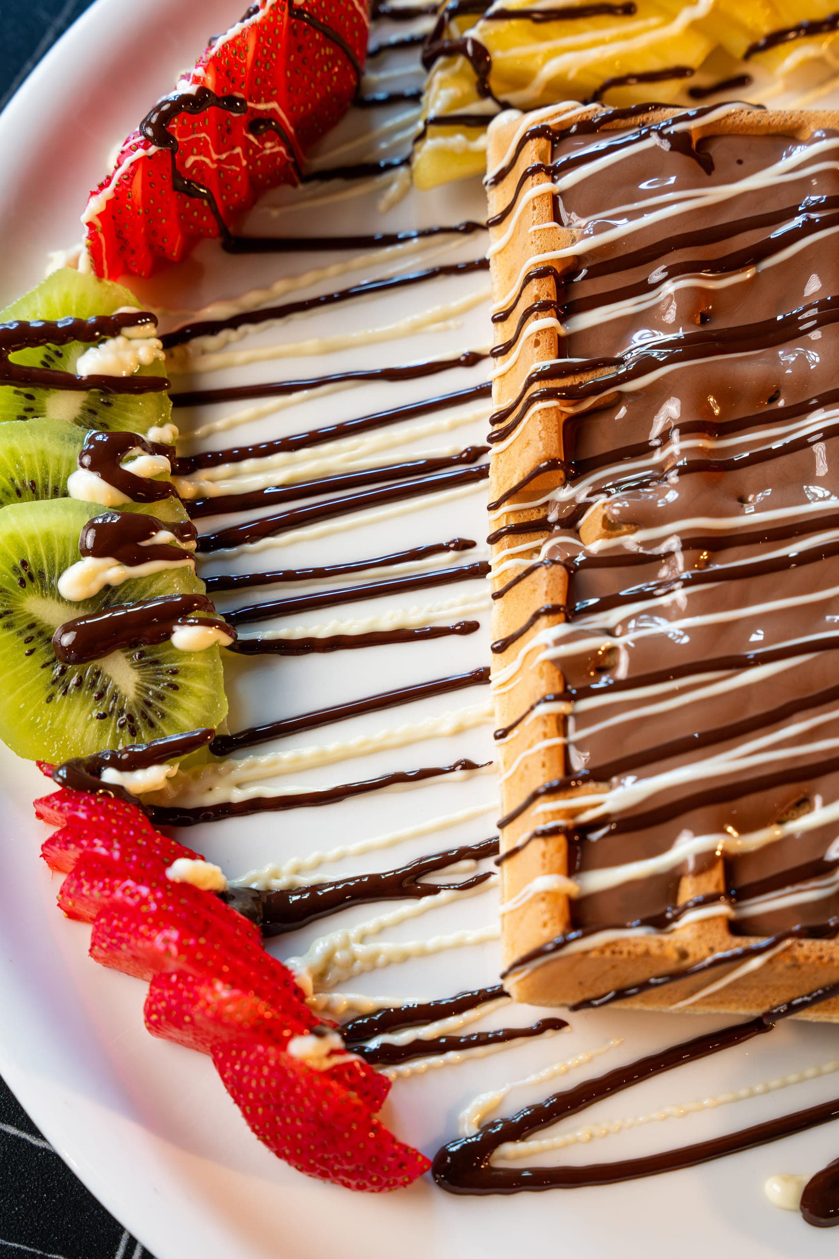 Crepe with strawberries, kiwi and a chocolate drizzle