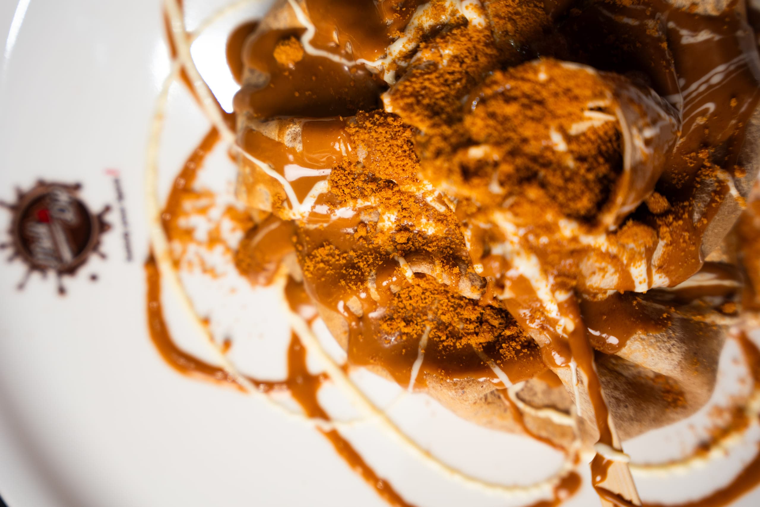 Plated dessert under a caramel drizzle