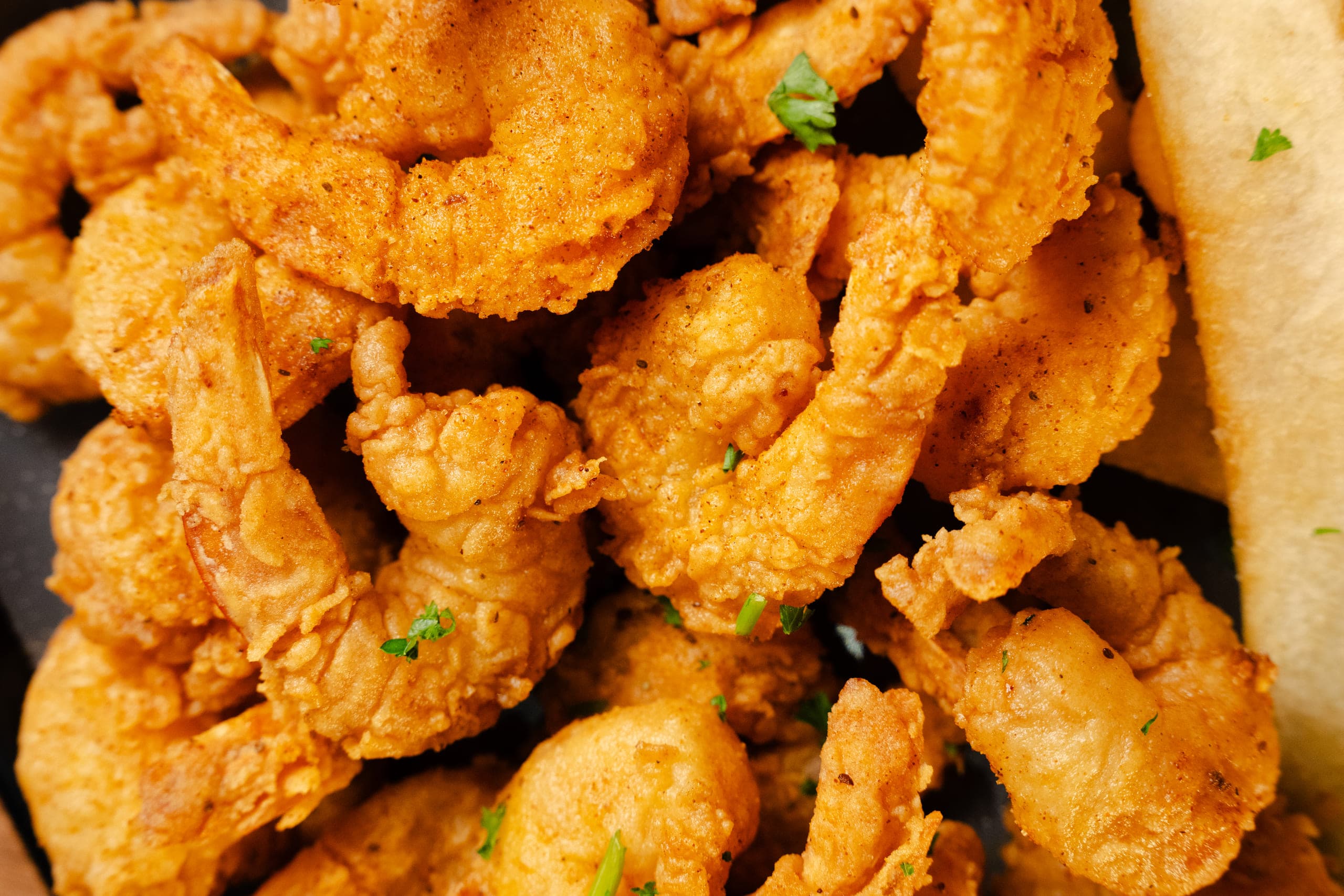 Golden fried shrimp piled close to the lens